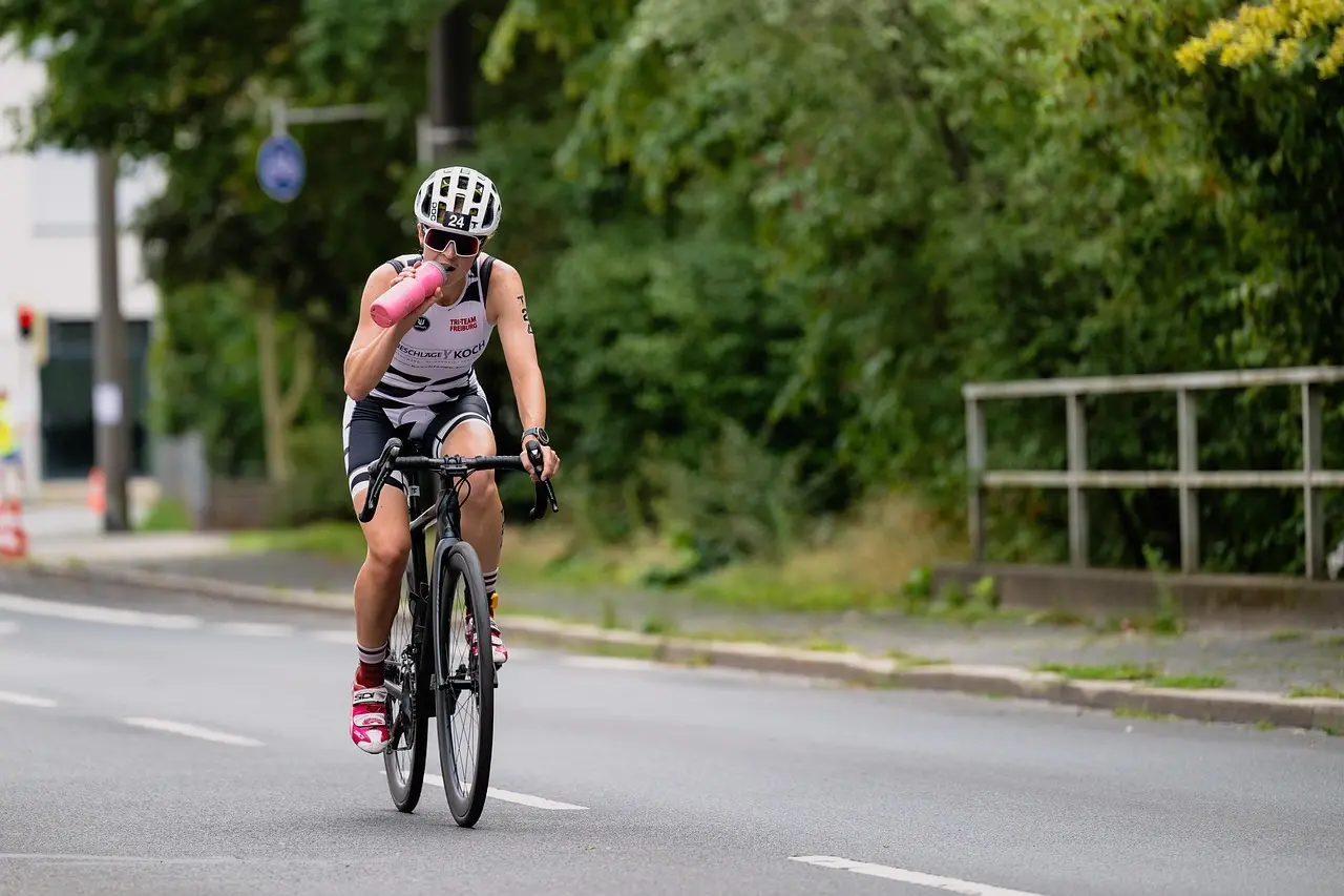 Cyklist drikker af drikkedunk på landevej